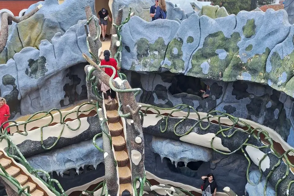 Visitors climb these narrow staircases between concrete trees.