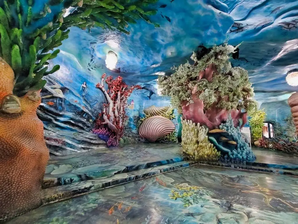 Ocean on the Plateau: a marine interior with corals and a painted ceiling.