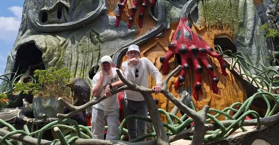 A fantastical Crazy House facade with enormous red hands.